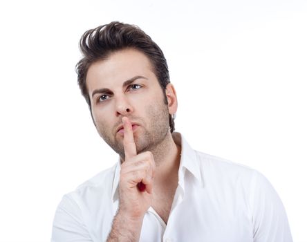 man in white shirt doing a silence gesture with forefinger - isolated on white