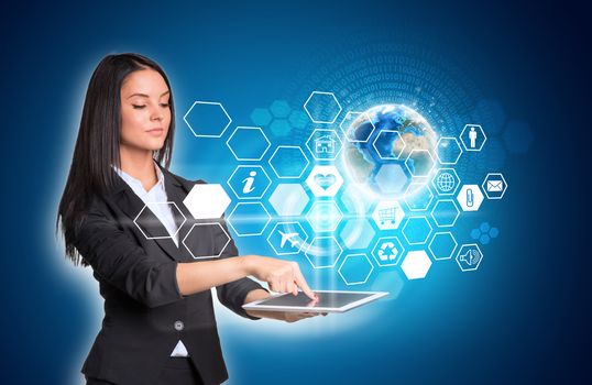 Beautiful businesswomen in suit using digital tablet. Earth and hexagons with icons. Element of this image furnished by NASA