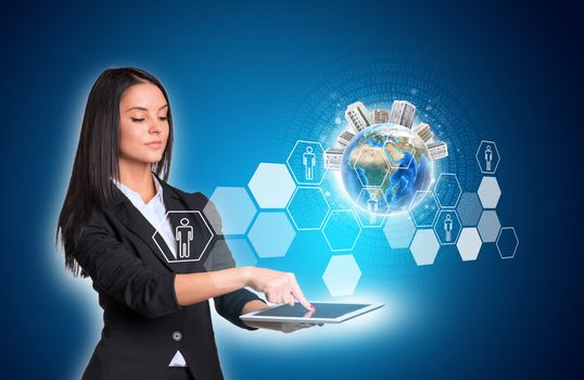 Beautiful businesswomen in suit using digital tablet. Earth with buildings and hexagons with icons. Element of this image furnished by NASA