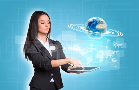Beautiful businesswomen in suit using digital tablet. Earth with world map and network. Element of this image furnished by NASA