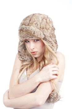 beautiful blond girl with blue eyes in fur hat - isolated on white