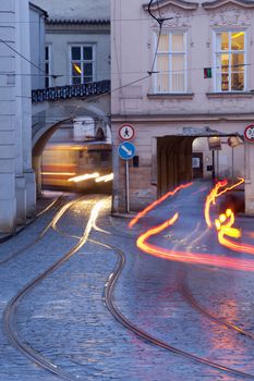 prague - cars and tramways passing under buildings at mala strana