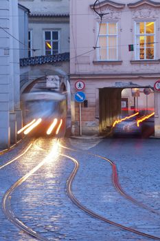 prague - cars and tramways passing under buildings at mala strana