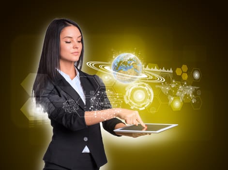 Beautiful businesswomen in suit using digital tablet. Earth with network, graphs and circles. Element of this image furnished by NASA
