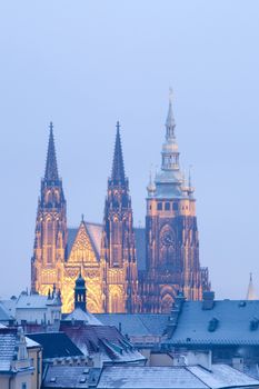 prague in winter - lesser town roofs and hradcany castle at dusk