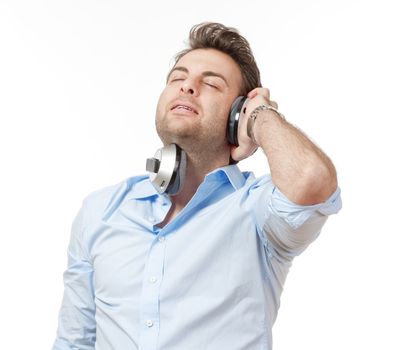 man in blue shirt with earphones listening to music - isolated on white