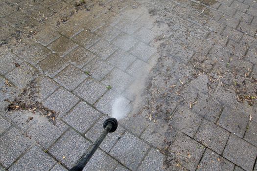 Outdoor floor cleaning with high pressure water jet