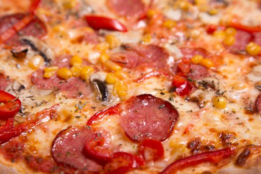 Close-up shot of tasty American pizza with pepperoni and mushrooms, selective focus  