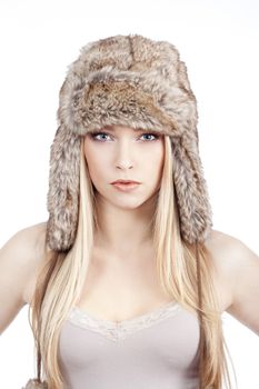 beautiful blond girl with blue eyes in fur hat - isolated on white