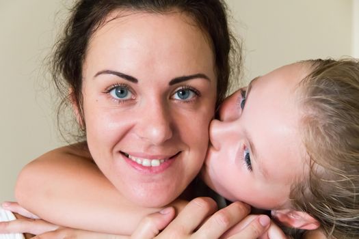 Photo of kissing mother and daughter