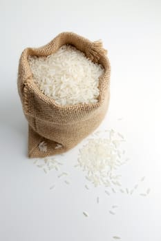 rice in burlap sack isolated on white
