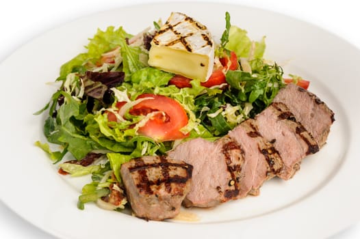 Grill roasted veal meat with fresh vegetable salad