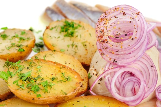 Roast potatoes with salted hering and onion rings