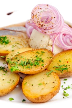 Roast potatoes with salted hering and onion rings