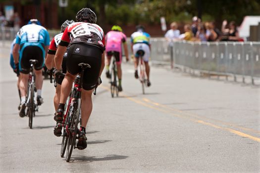 Duluth, GA, USA - August 2, 2014:  Amateur cyclists sprint down a straightaway on a downtown Duluth street as they compete in the Georgia Cup Criterium event.  