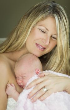 Young Caucasian Beautiful Mother Holding Her Precious Newborn Baby Girl.