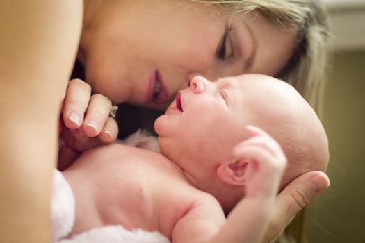 Young Caucasian Beautiful Mother Holding Her Precious Newborn Baby Girl.