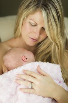 Young Caucasian Beautiful Mother Holding Her Precious Newborn Baby Girl.