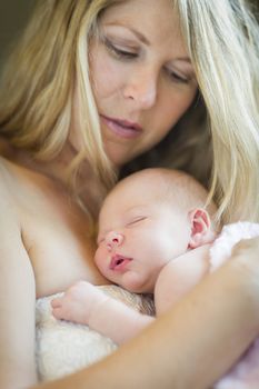 Young Caucasian Beautiful Mother Holding Her Precious Newborn Baby Girl.