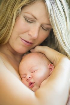 Young Caucasian Beautiful Mother Holding Her Precious Newborn Baby Girl.