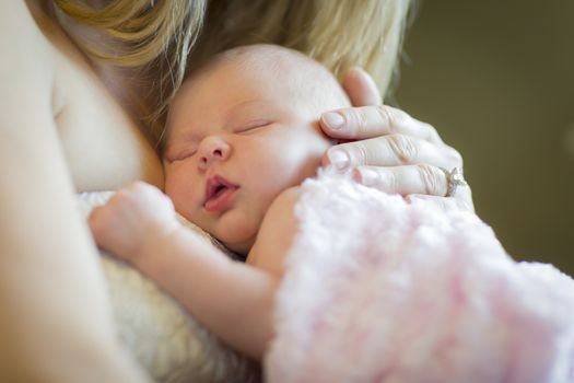 Gentle Hands of Mother Holding Her Precious Newborn Baby Girl.