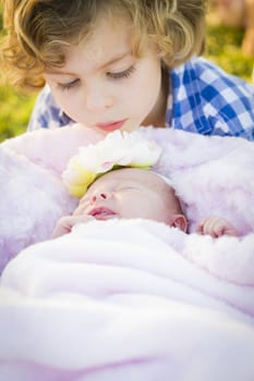 Cute Young Boy Gazing at His Newborn Baby Girl Sister.