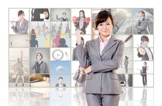 Attractive Asian business woman standing in front of TV screen wall.