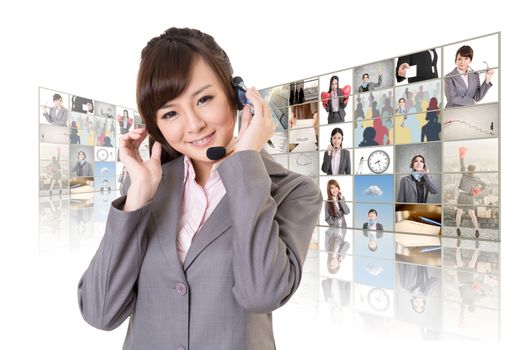 Business woman with headphone standing in front of TV screen wall.