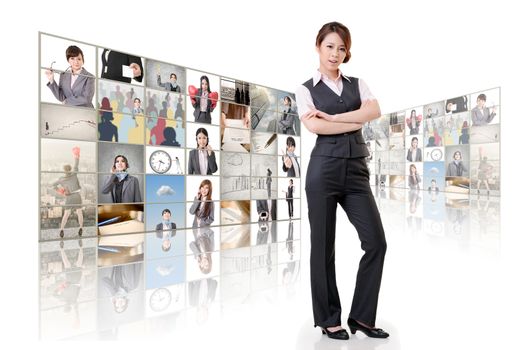 Attractive Asian business woman standing in front of TV screen wall.