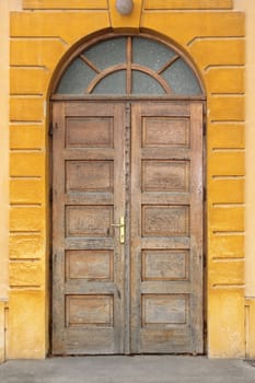 old wooden traditional door on building facade
