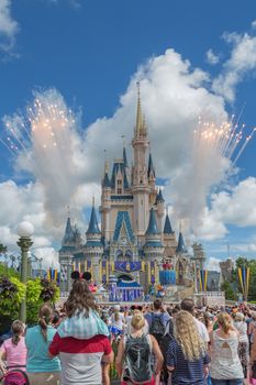 Orlando, Florida – Sept 4: A large crowd gathers to watch the spectacular fireworks accompanying a musical performance at Disney Magic Kingdom in Orlando, Florida, on September 4, 2014