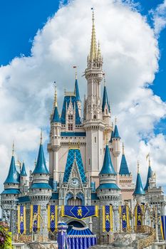 Orlando, Florida – Sept 4: The famous Disney Magic Kingdom Castle soars into the clouds in Orlando, Florida, on September 4, 2014