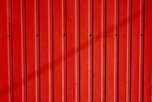 Scarlet corrugated metal fence as a background                               