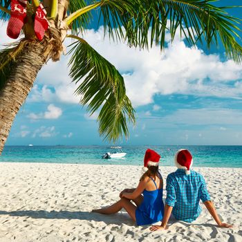 Couple in blue clothes on a tropical beach at christmas