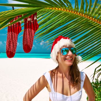 Woman in bikini on a tropical beach at christmas