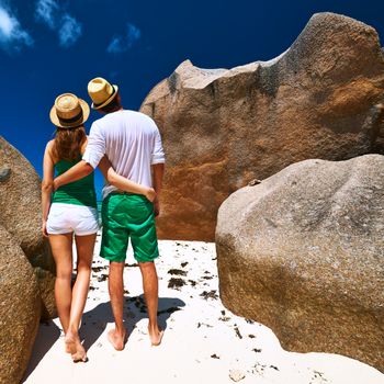 Couple in green on a tropical beach at Seychelles