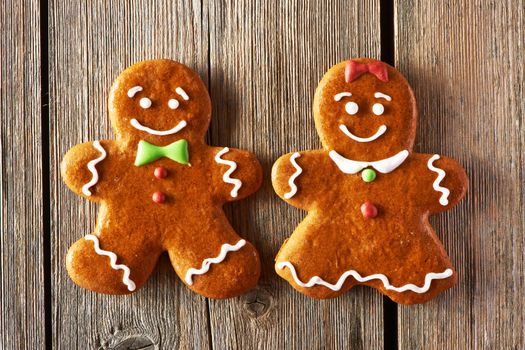 Christmas homemade gingerbread couple cookies on wooden table