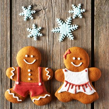 Christmas homemade gingerbread couple cookies on wooden table