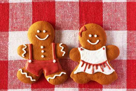 Christmas homemade gingerbread couple on tablecloth