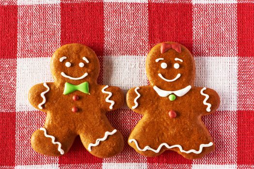 Christmas homemade gingerbread couple on tablecloth