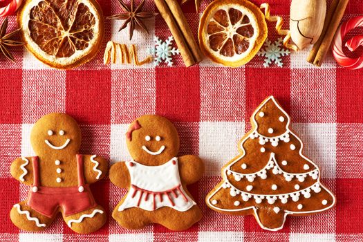 Christmas homemade gingerbread couple and tree on tablecloth