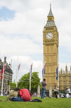 LONDON, UK - JUNE 01: Couples in Parliament Square with Big Ben in the background. June 01, 2014 in London.