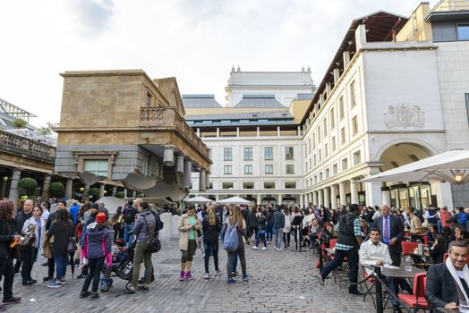 LONDON, UK - OCTOBER 05: Tourist observing artwork by artist Alex Chinneck in Covent Garden. The floating piazza will remain there until the end of the month. October 05, 2014 in London.