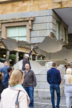 LONDON, UK - OCTOBER 05: Tourist observing artwork by artist Alex Chinneck in Covent Garden. The floating piazza will remain there until the end of the month. October 05, 2014 in London.