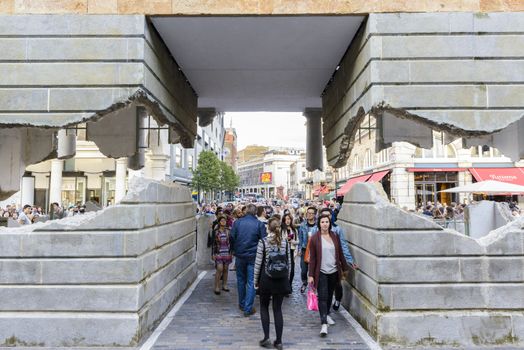 LONDON, UK - OCTOBER 05: Tourist observing artwork by artist Alex Chinneck in Covent Garden. The floating piazza will remain there until the end of the month. October 05, 2014 in London.