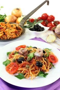 Capellini with tomatoes, anchovies, capers and olives