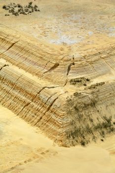 Aerial view of a corner of a gold mine dump with erosion down the side.