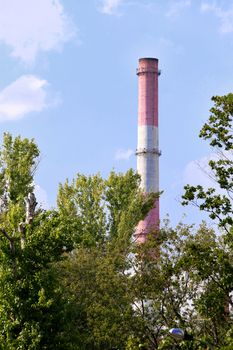 pipes of thermal power plant against blue sky