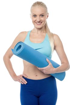 Young fitness woman holding exercise mat