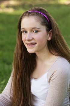 Smiling teenage white female with braces on teeth